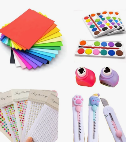 Assorted basic craft materials including colorful paper sheets, watercolor palettes, paper punches, decorative gem stickers, and utility knives