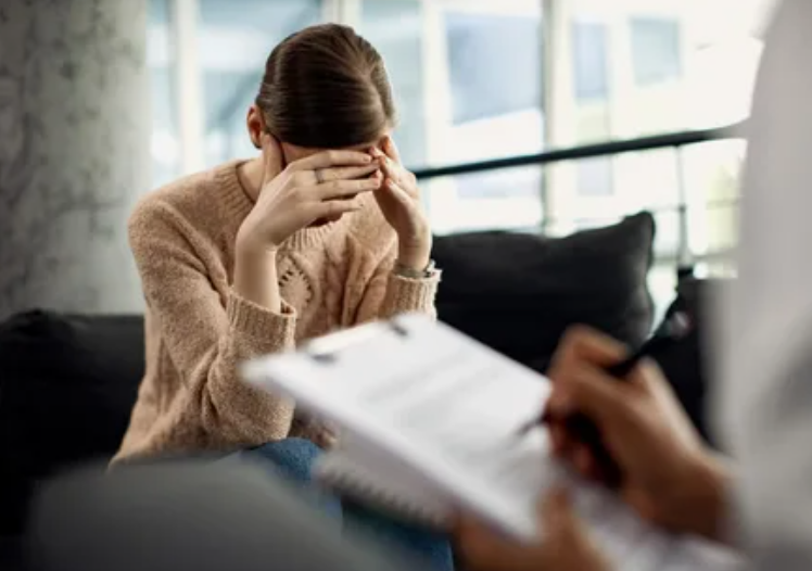 "A woman talking to a therapist during a counseling session, representing emotional health and mental well-being as a key component of the 5 pillars of wellness."