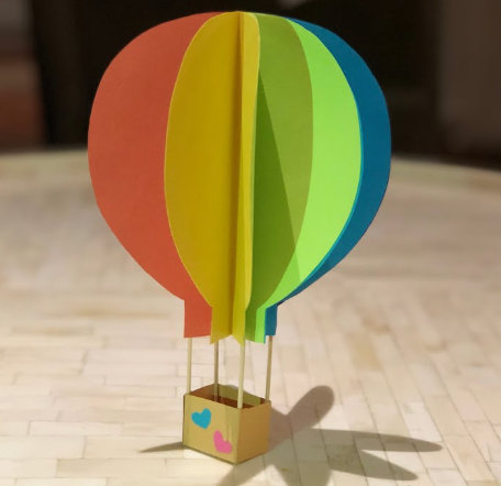 A 3D hot air balloon made with colorful paper panels and a small basket, featured as part of easy paper crafts.
