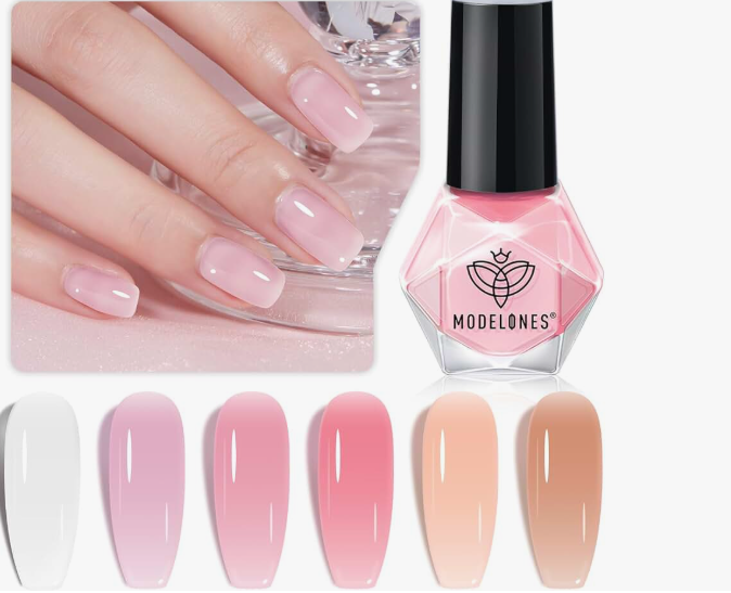 What nail colour is trending now displayed in a collection of glossy pastel pink and milky gradient shades next to a Modelones pink nail polish bottle.