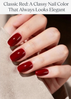 A close-up of a woman's hand with a flawless glossy classic red manicure, a timeless classy nail color that is perfect for any elegant occasion and featured on Humor Craze.