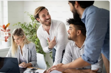 Diverse team of professionals collaborating and smiling during a meeting in a bright office