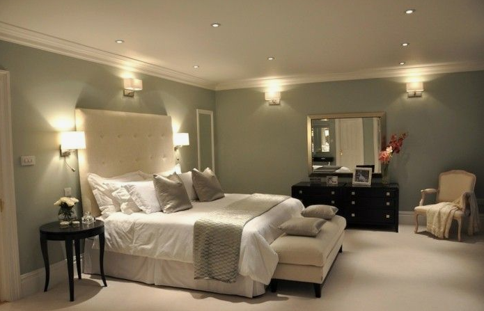 What Home Decor Items Are Trending in 2026? 15 Ideas to Refresh Your Home what home decor items are trending in 2026 highlighting an elegant bedroom design with soft green walls, a tufted headboard, and ambient wall sconces">