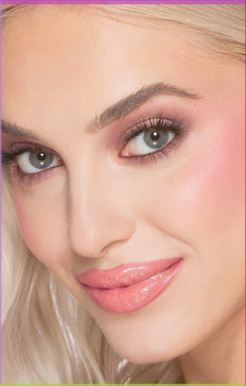 10 Makeup Trends for 2026: The Beauty Looks Everyone Will Want to Try A close-up portrait of a fair-haired model showcasing makeup trends 2026 with soft pink lipstick, subtle smokey eye makeup, defined brows, and a glowing complexion.