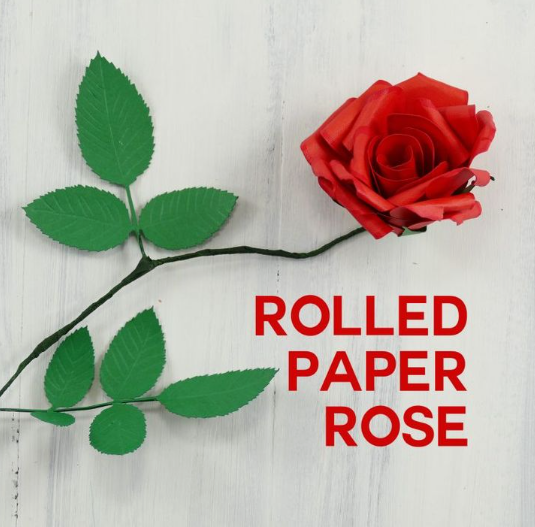 15 Easy DIY Paper Flowers for Kids: Fun Crafts for Toddlers, Preschoolers & Older Children A single red rolled paper rose with a dark stem and green leaves on a white background, featuring the text "ROLLED PAPER ROSE," great for easy paper flowers for kids.