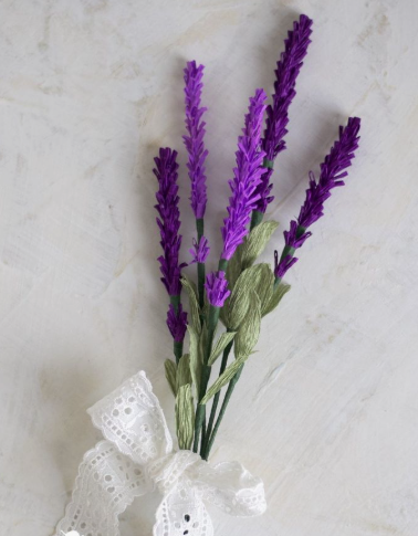 15 Easy DIY Paper Flowers for Kids: Fun Crafts for Toddlers, Preschoolers & Older Children A small bouquet of handmade purple paper lavender stems with green leaves, tied together with a white lace ribbon bow, perfect for easy paper flowers for kids.
