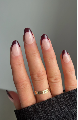 25 Short Fall Nail Ideas for 2026: Chic, Simple & Trendy Designs Short fall nail ideas 2026 featuring neat, short oval nails styled with rich dark burgundy French tips over a nude base.