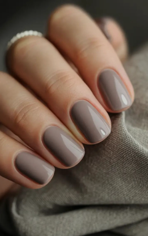 25 Short Fall Nail Ideas for 2026: Chic, Simple & Trendy Designs Short fall nail ideas 2026 showcasing short, squared nails finished in a glossy greige polish.
