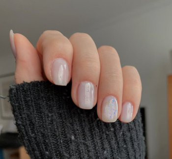 25 Short Fall Nail Ideas for 2026: Chic, Simple & Trendy Designs Short fall nail ideas 2026 showcasing short, squared nails finished in a glossy milky white or translucent shade with a delicate iridescent flake accent nail.