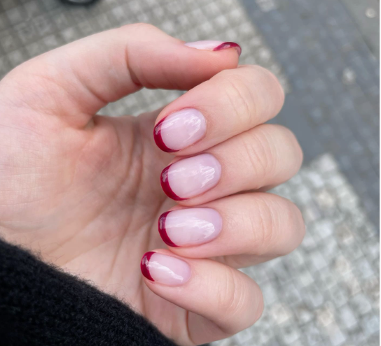 25 Short Fall Nail Ideas for 2026: Chic, Simple & Trendy Designs Short fall nail ideas 2026 showcasing short, rounded nails styled with glossy burgundy red French tips over a neutral base.