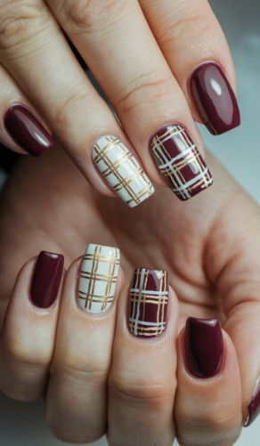 25 Short Fall Nail Ideas for 2026: Chic, Simple & Trendy Designs Short fall nail ideas 2026 showcasing short, squared nails featuring a mix of solid dark burgundy polish and intricate white and gold plaid accent designs.
