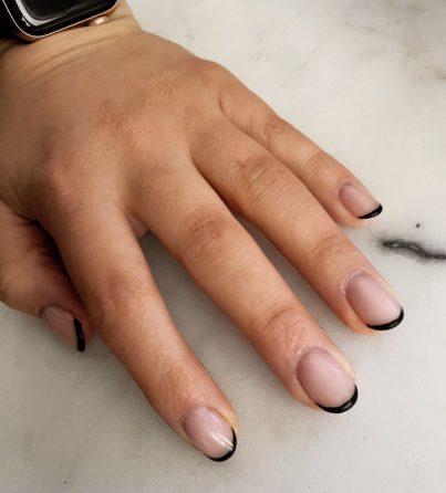 25 Short Fall Nail Ideas for 2026: Chic, Simple & Trendy Designs Short fall nail ideas 2026 showcasing short, rounded nails styled with glossy black French tips over a neutral base.