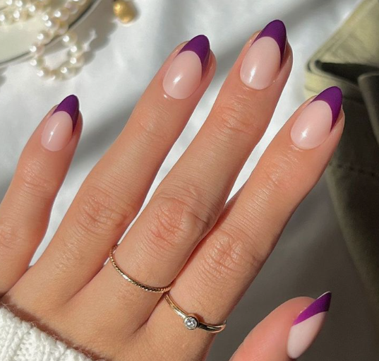 25 Short Fall Nail Ideas for 2026: Chic, Simple & Trendy Designs Short fall nail ideas 2026 showcasing short, oval nails styled with glossy deep purple French tips over a neutral base.