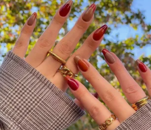 25 Short Fall Nail Ideas for 2026: Chic, Simple & Trendy Designs Short fall nail ideas 2026 showcasing almond-shaped nails styled with glossy autumn-toned French tips in shades of red, rust, and brown over a neutral base.