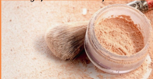 20 Types of Makeup and Their Uses: A Complete Beginner’s Guide Open jar of translucent loose setting powder next to a fluffy makeup brush for types of makeup and their uses.