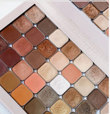 20 Types of Makeup and Their Uses: A Complete Beginner’s Guide Large eyeshadow palette featuring a variety of neutral shimmer and matte shades for types of makeup and their uses.