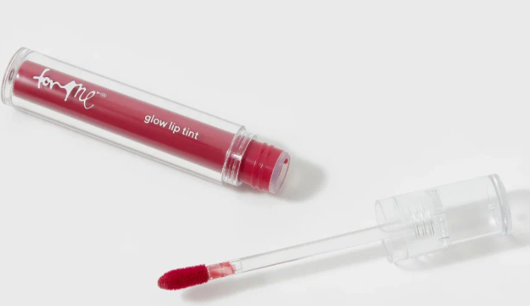 20 Types of Makeup and Their Uses: A Complete Beginner’s Guide Open tube of For Me Glow Lip Tint featuring a pink shade and a doe-foot applicator for types of makeup and their uses.