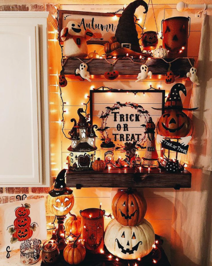 Two rustic wooden wall shelves densely packed with festive items embodying creative Halloween decor ideas for indoor spaces.