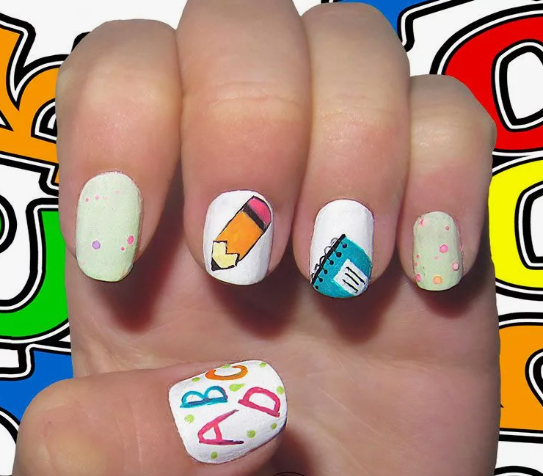 18 Back-to-School Nail Designs for a Fresh Start This School Year Close-up of fun back-to-school nail designs featuring a pastel color palette with painted school supply motifs including a pencil, notebook, colorful polka dot accents, and ABC letters.