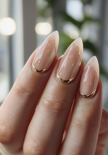 18 Back-to-School Nail Designs for a Fresh Start This School Year Close-up of chic back-to-school nail designs featuring polished almond nails with minimalist metallic gold chrome French tips and delicate side accents.