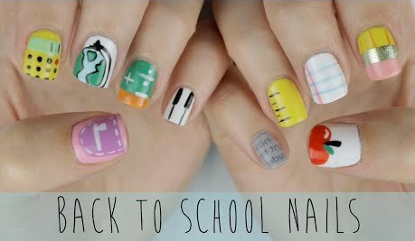 18 Back-to-School Nail Designs for a Fresh Start This School Year Close-up of creative back-to-school nail designs featuring a fun assortment of school-themed motifs painted across both hands, including a calculator, ruler, notebook paper, pencil, apple, and piano keys.