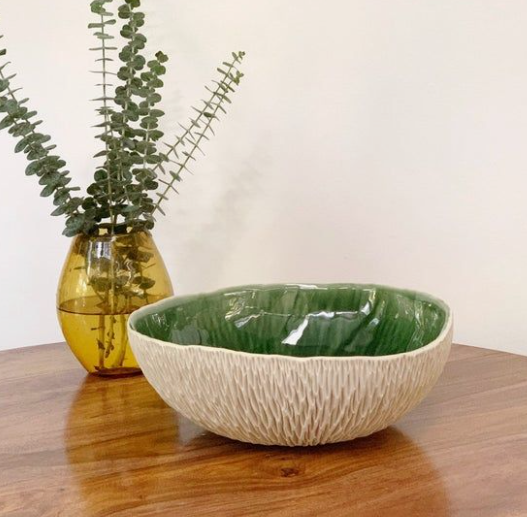 A textured handmade bowl with a green interior and a ribbed exterior, showcasing unique air dry clay ideas for functional home decor and tabletop styling.