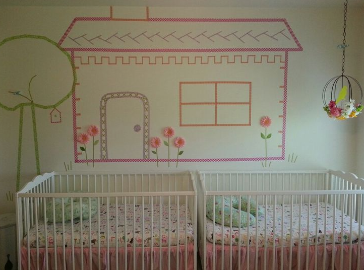 10 DIY Dorm Room Decor Ideas on a Budget That Look Amazing DIY dorm room decor ideas on a budget featuring a large wall mural created with colorful washi tape in the shape of a house, tree, and flowers, positioned above two white cribs and a decorative hanging birdcage.