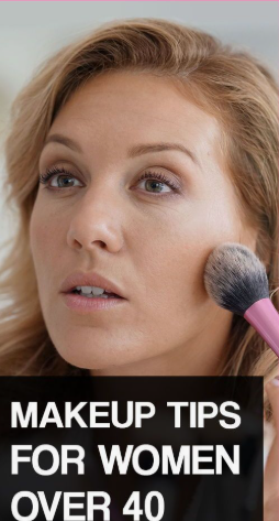 A woman applying makeup to her cheek with a fluffy brush, accompanied by text overlay reading "Makeup Tips For Women Over 40," showcasing beauty tips for women over 40.