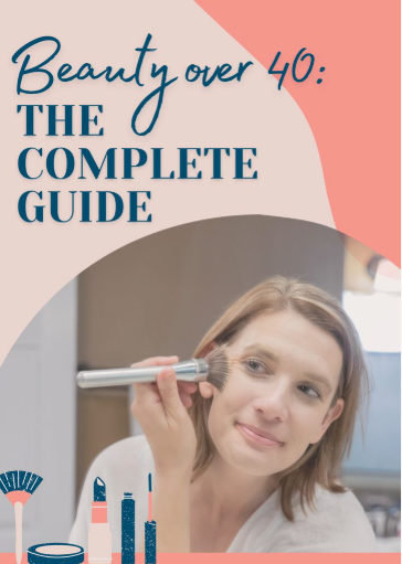 A woman applying makeup with a brush beneath bold text reading "Beauty over 40: The Complete Guide," showcasing beauty tips for women over 40.