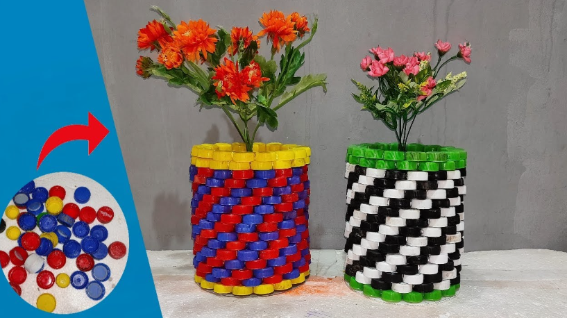 20 Recycled Household Item Crafts for a Creative Home Two decorative flower vases created as recycled household item crafts from plastic bottle caps, with one featuring a red, blue, and yellow spiral pattern holding orange flowers, and the other designed in black, white, and green holding pink flowers.