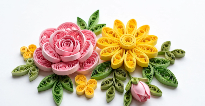 25 Analog Crafts to Do Instead of Scrolling Handcrafted paper quilling flower arrangement featuring a pink rolled rose, yellow daisy, and green leaves, showcasing analog crafts to do instead of scrolling.