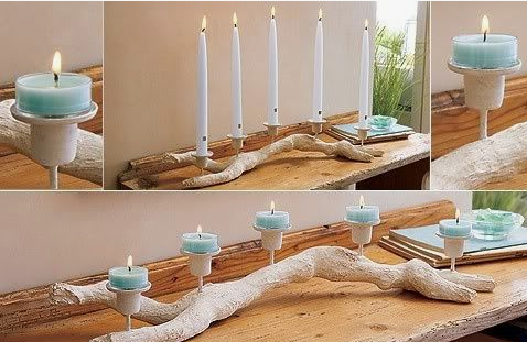 "A driftwood branch candle holder styled with white taper candles and light blue tealights, showcased as part of 25 easy DIY home decor crafts for rustic table centerpieces."
