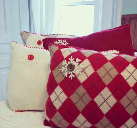 20 DIY Crafts With Old Clothes That Are Easy to Make Decorative throw pillows made from upcycled sweaters featuring argyle patterns, buttons, and snowflake appliqués, showcasing creative DIY crafts with old clothes.