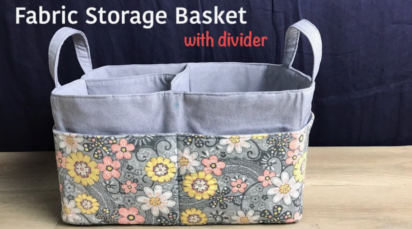 20 DIY Crafts With Old Clothes That Are Easy to Make A handmade fabric storage basket with a divider and handles, featuring floral print panels upcycled from old clothing, showcasing creative DIY crafts with old clothes.