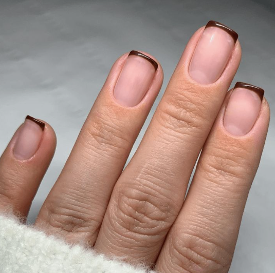 Brown nail ideas for short nails featuring micro French tips in dark chocolate brown on short square nails with a sheer nude base