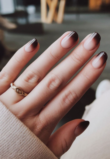 Brown nail ideas for short nails featuring a moody ombre gradient transitioning from nude pink to deep dark brown tips on short oval nails