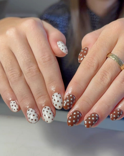 Brown nail ideas for short nails featuring playful polka dot patterns with brown and white contrasting colors on short oval nails