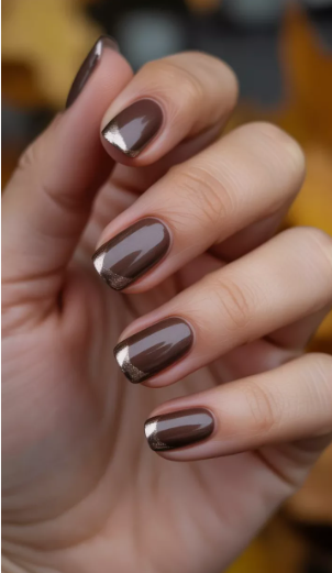 Brown nail ideas for short nails featuring glossy medium brown polish paired with metallic bronze glitter tips on short square nails