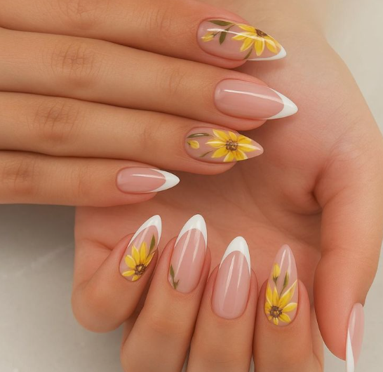24 Sunflower Nail Ideas for a Bright, Cheerful Manicure sunflower nail ideas featuring elegant almond-shaped nails combining classic white French tips with delicate accent nails showcasing hand-painted yellow sunflowers and green stems on a sheer nude base.