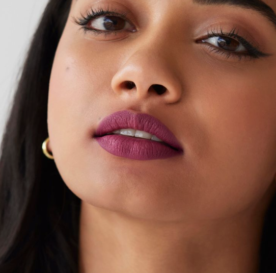 Matte Lipstick Styles in 2026: Modern Looks, Shades & Easy Tips Close-up of a model wearing a rich orchid-purple matte lipstick with a clean, velvety finish.