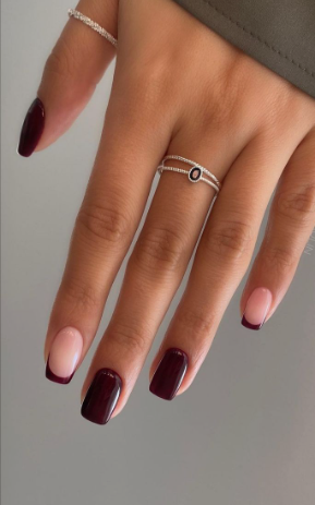 Sophisticated square-shaped burgundy nail designs featuring a chic alternating combination of solid glossy deep maroon polish and classic dark red French tips on a nude base