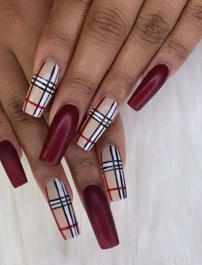 Stylish long square burgundy nail designs featuring a striking mix of velvety matte dark red polish and classic beige Burberry-inspired plaid accent art.