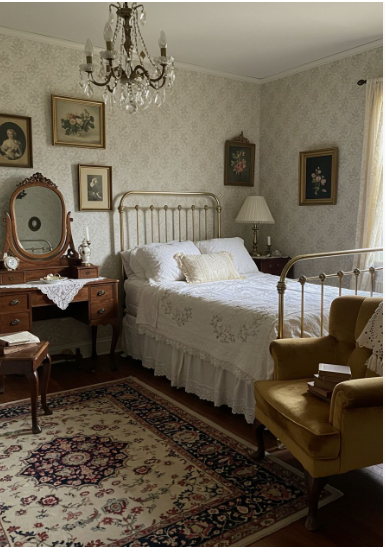 Vintage Modern Home Decor Ideas: 15 Ways to Mix Old and New "A cozy vintage bedroom highlighting Vintage Modern Home Decor Ideas, featuring a metal frame bed with white bedding, a crystal chandelier, an antique vanity with a swivel mirror, a mustard armchair, and a patterned area rug."