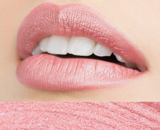 Spring 2026 lipstick trends showcased in a close-up macro view of glossy, neutral pink lipstick worn on lips showing a hint of white teeth, with a matching lipstick swatch strip at the bottom.   