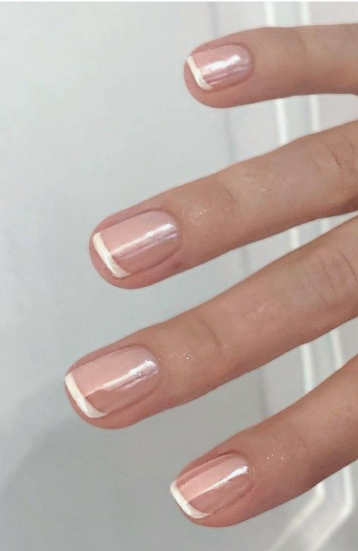 Short square nails with a glazed pink chrome finish and classic white French tips.
