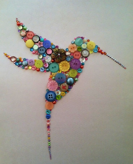 30 Creative DIY Button Crafts to Turn Spare Buttons Into Beautiful Decor A vibrant hummingbird mosaic artwork meticulously crafted from a colorful assortment of buttons, beads, and crystals, highlighting DIY button crafts.