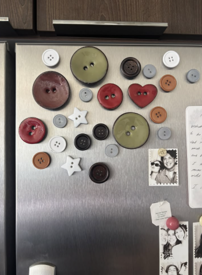 30 Creative DIY Button Crafts to Turn Spare Buttons Into Beautiful Decor A refrigerator door decorated with an array of colorful oversized button magnets in various shapes like stars and hearts, showcasing DIY button crafts.