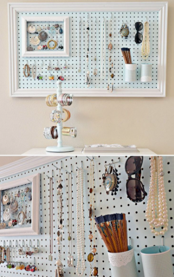 Small bedroom idea with no closet featuring a wall-mounted light blue pegboard framed in white to neatly hang and organize jewelry, sunglasses, brushes, and accessories above a tabletop bracelet holder.