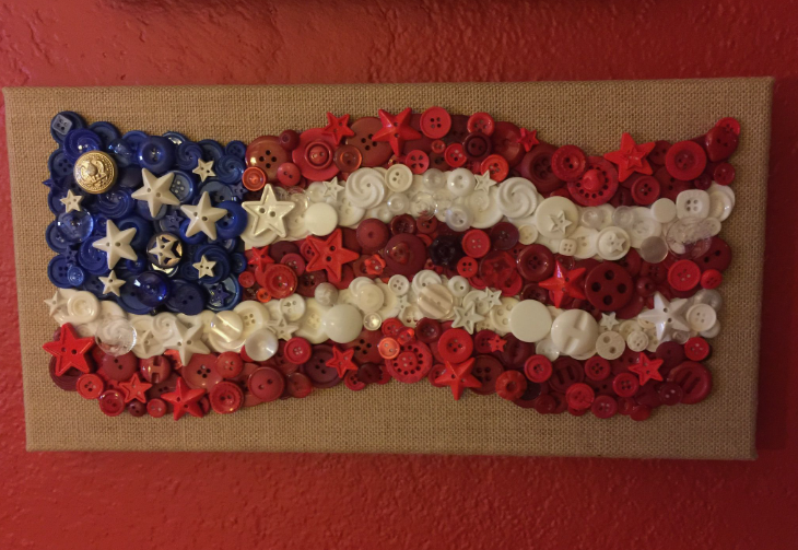 30 Creative DIY Button Crafts to Turn Spare Buttons Into Beautiful Decor A patriotic wall art canvas depicting an American flag styled as a waving banner, meticulously created from layers of red, white, and blue buttons with star-shaped accents, highlighting DIY button crafts.