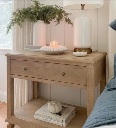 Small Bedroom Layout Ideas: How to Arrange Furniture in a Tiny Room Small bedroom layout idea featuring a rustic wooden nightstand styled with a table lamp, vase of greenery, decorative candle, and stacked books on the bottom shelf.